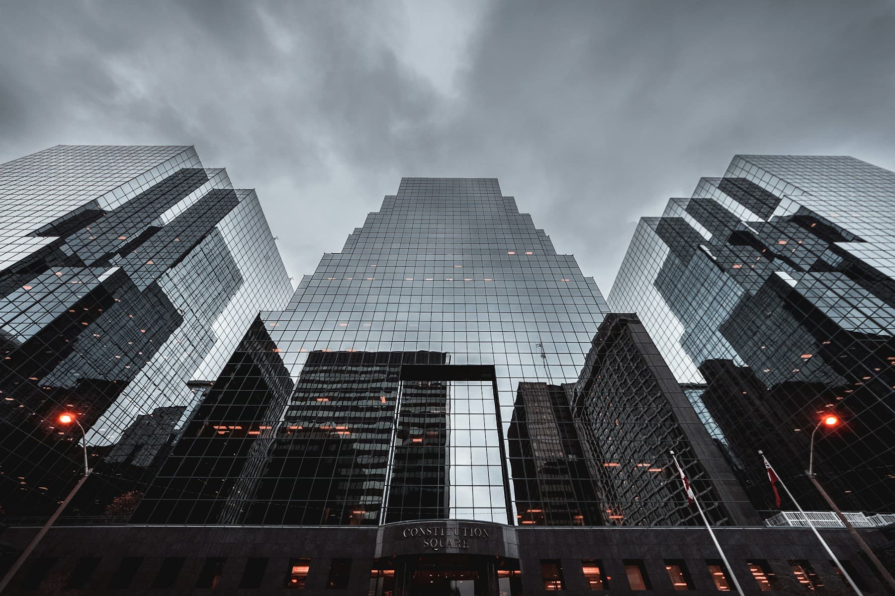 Modern glass and concrete building facade viewed from below